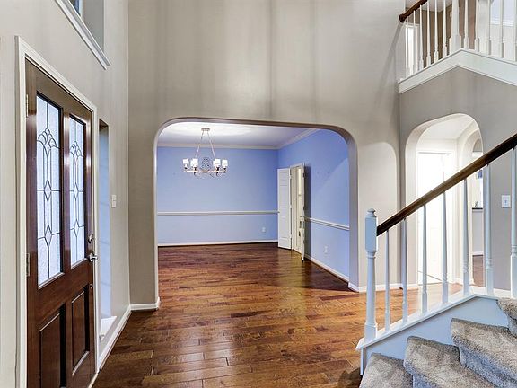 From the entrance to your left is the formal Dining Room, looking almost straight ahead is the Den area and of course the stairs to the second floor.
