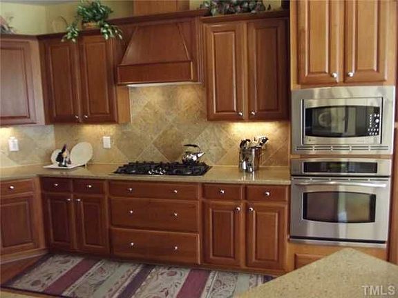 Maple cabinets, SS, zodiac quartz counters, hardwood floors
