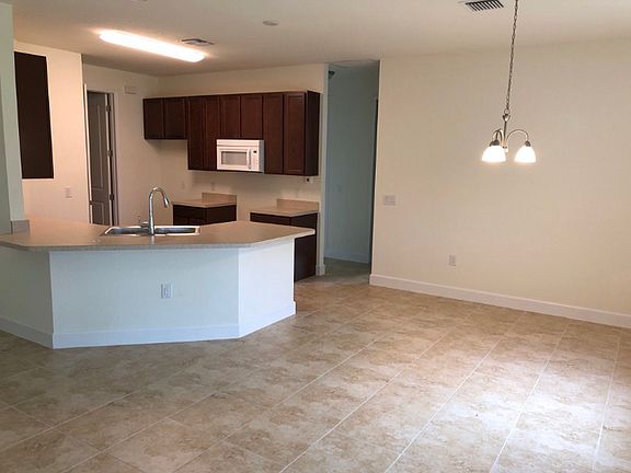 18 Tile throughout, except for carpeted bedrooms and laminate in Den.