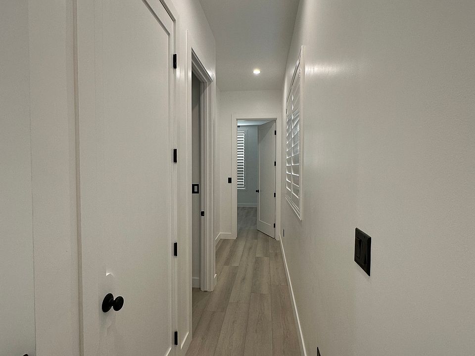 Upstairs hallway (laundry closet 1st door on the left, Bedroom 1 next, Bedroom 2 at end of hall)