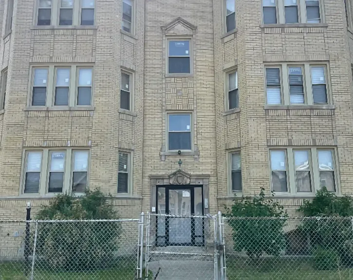 Front of the building with double security doors.