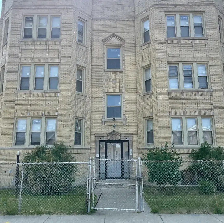 Front of the building with double security doors.