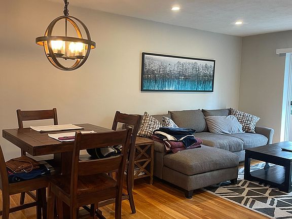 Closer view of the dining table and living room.