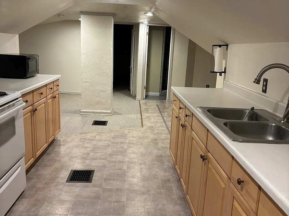 Looking through kitchen and towards living room, and bedroom and bathroom.