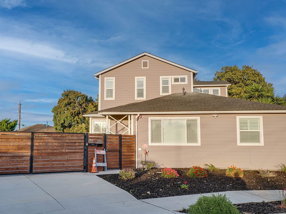 Front of home with private gate parking