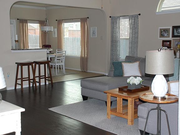 Spacious living area with fireplace and wood floors