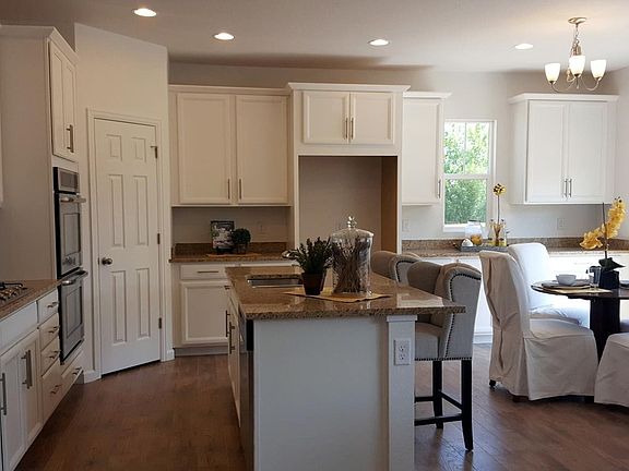 Gourmet kitchen w dbl ovens, gas cooktop, island, and slab granite