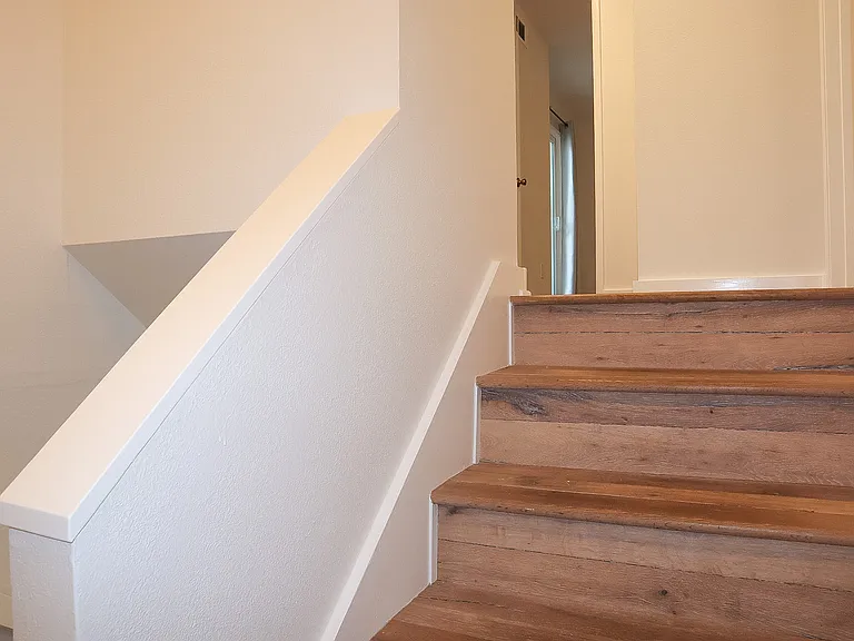 Stairway with hardwood steps.