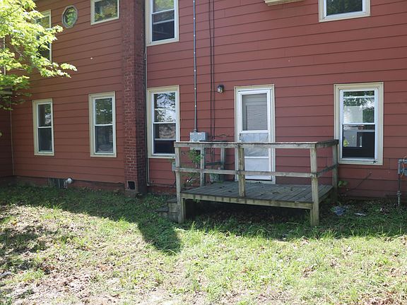 Back of house. Small deck off kitchen.