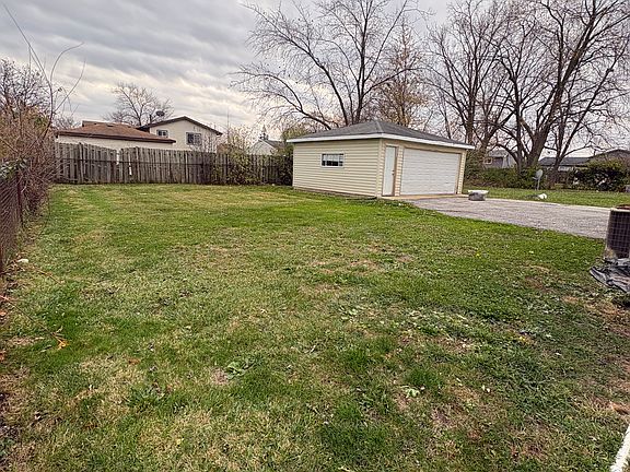 Backyard view with 2-car garage
