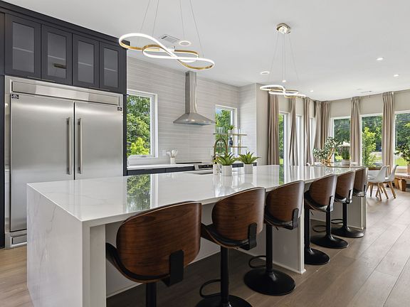 designer kitchen with MASSIVE island, open floor plan perfect for relaxing and entertaining.