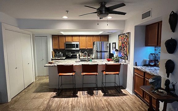 Soft leather counter stools. Coffee bar to right. Full sized laundry buildout on left.