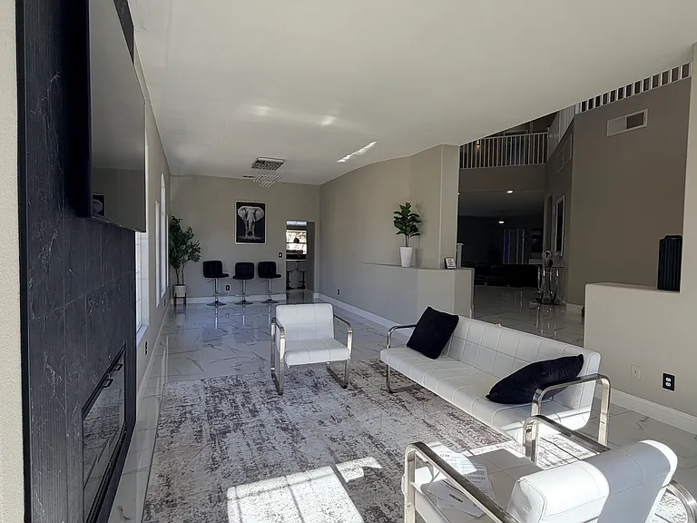 Inviting sitting area just off the entry, offering flexible space for lounging or additional entertainment.