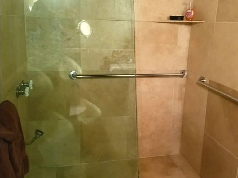 Guest bathroom with handicap railings.