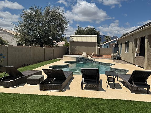 Backyard features new turf, large patio surrounding newly remodeled heated pool and spa.
