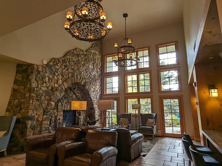 Welcoming common living area with large gas fireplace, a TV and entertainment area, and a pool table.