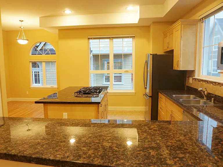 huge kitchen with granite counter tops and island.