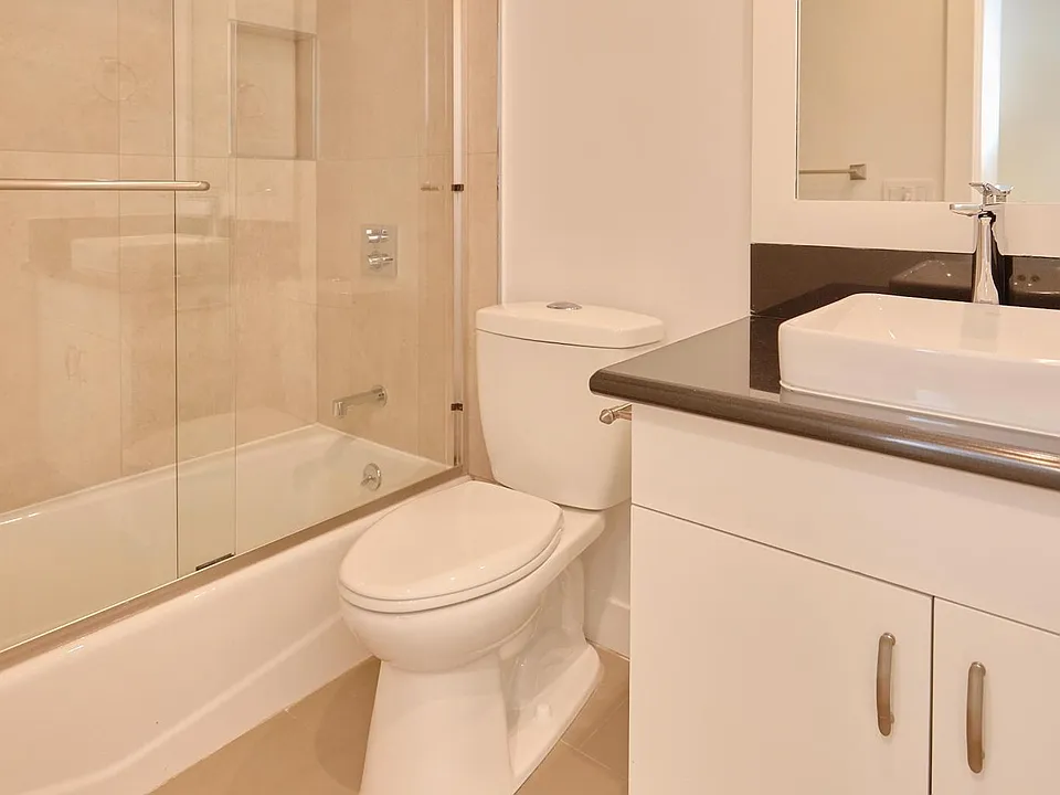 Second Bathroom with quartz counters, custom cabinets, designer tile and tub/shower combo with glass enclosure