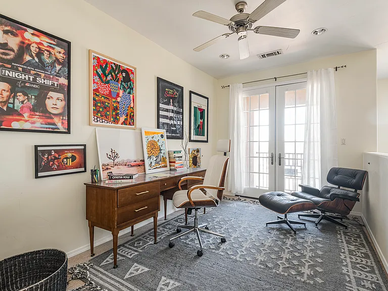 Flexible third-floor space with French doors, ideal for a home office or gym.