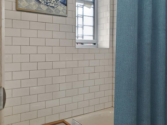 Visually enhanced. Nice tiled bathroom.