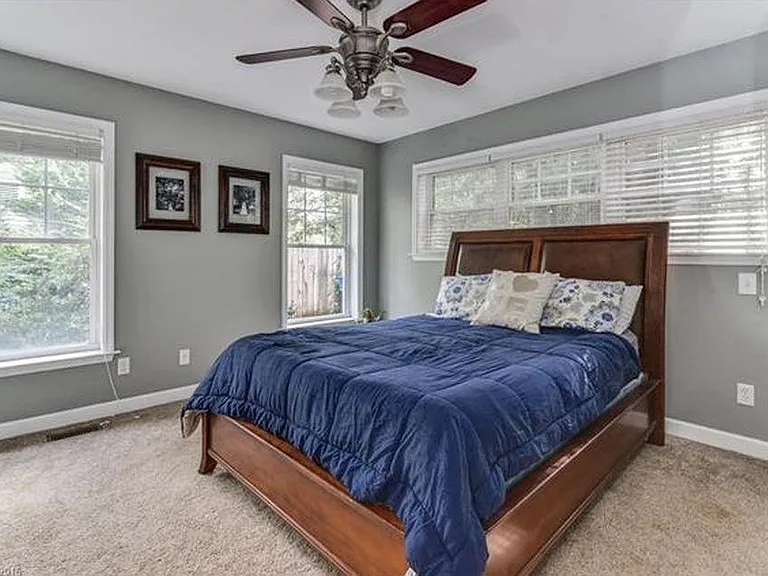 Primary bedroom gets lots of natural light and has two closets.