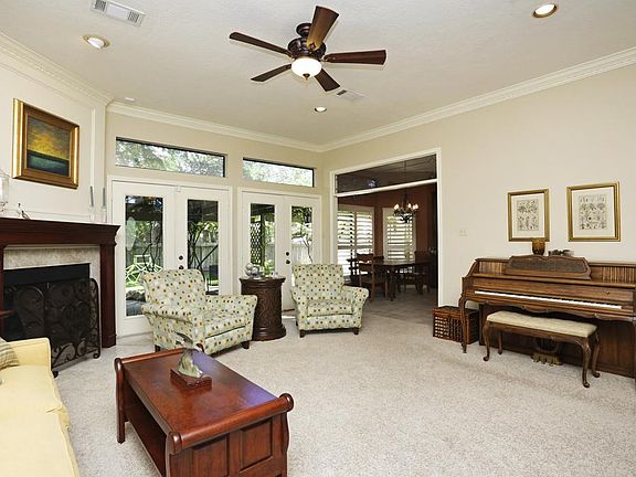 The living room features beautiful millwork, transoms and french doors, allowing for streams of ligh