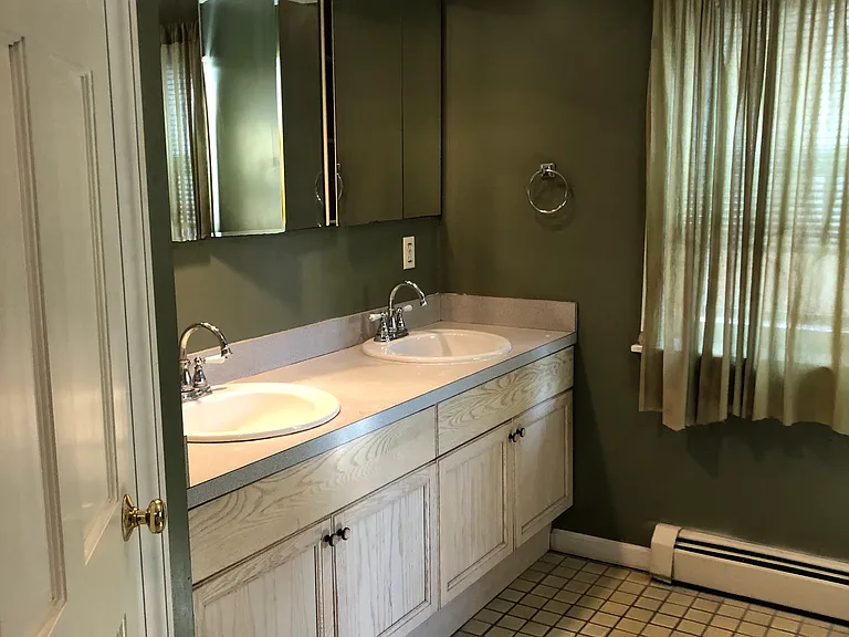 Full bath with two vanities.