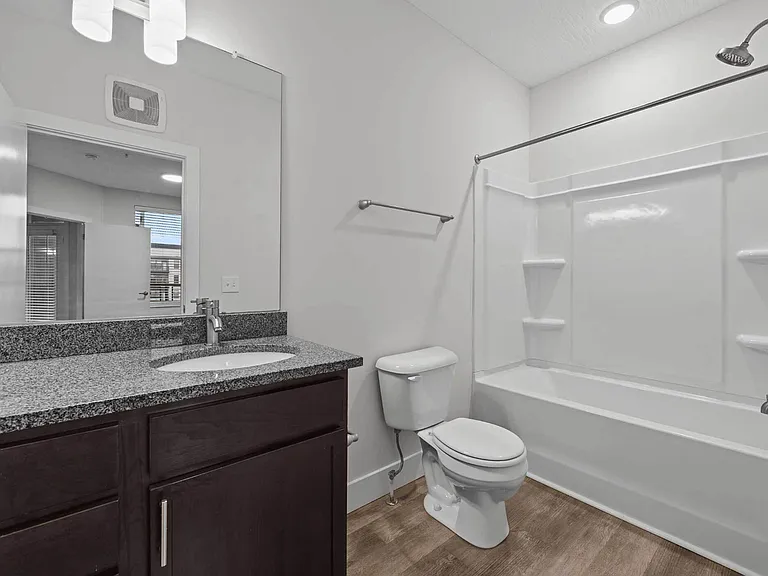 Retreat to a spacious primary suite with plush carpeting, abundant natural light, and a walk-in closet _ a peaceful escape in your Clintonville two-bedroom apartment. Retreat to a spacious primary suite with plush carpeting, abundant natural light, and a 