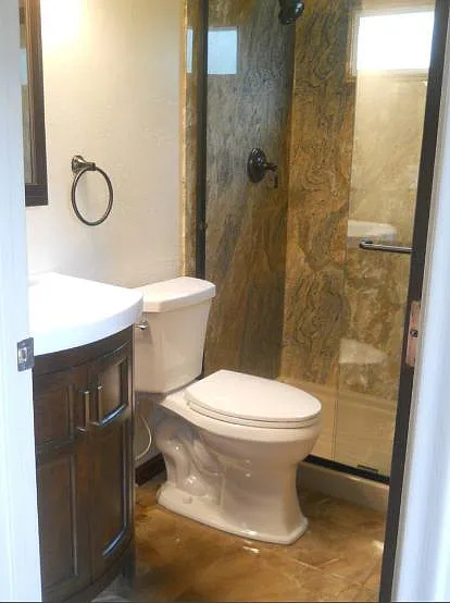 Main bedroom en-suite bathroom. European style vanity with quiet close doors with hidden drawer in the bottom sitting atop beautiful natural stone tile floor