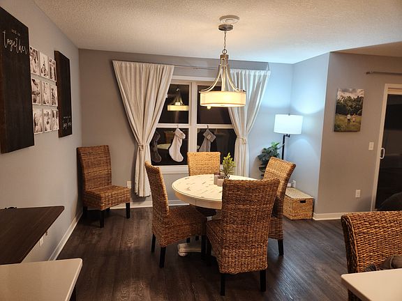 Bright and inviting dining room.

 The dining space features a hanging light fixture, a large area for table and chairs, and large windows that bring in plenty of natural light.