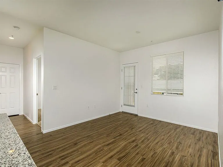 Patio door with a window on the side and spacious living room