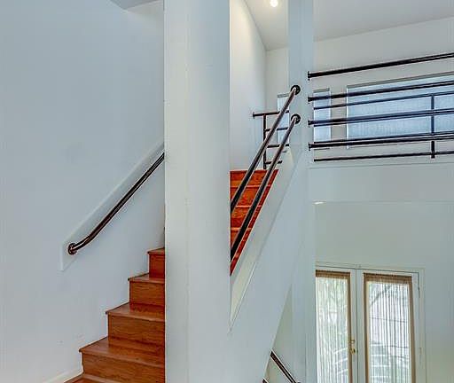 FOYER FEATURES SLATE FLOORS AND STAIRS WITH WOOD TREAD.