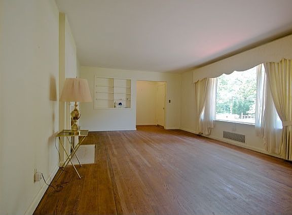 Another view of the living room with built-in bookshelves