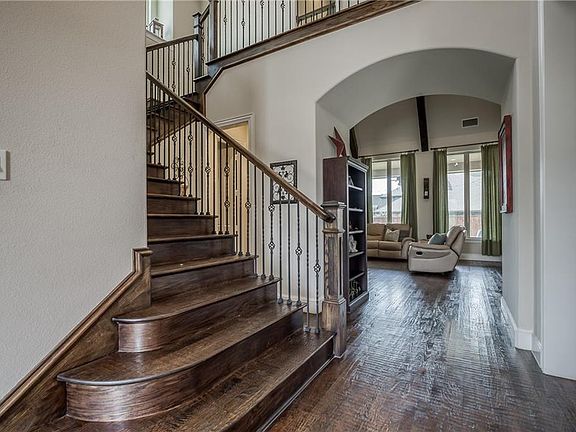 This welcoming entry has hand scraped wood steps and floors.