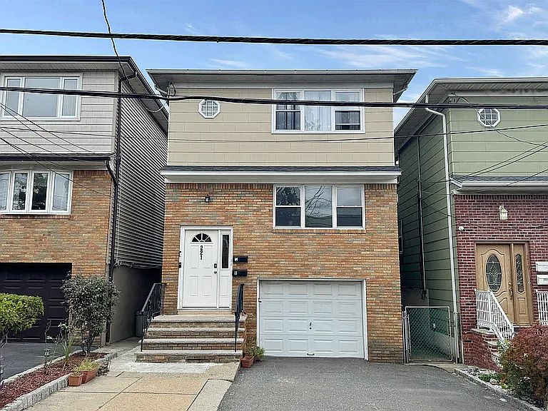 Front of house, driveway, garage door