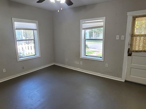 Living room boasts lots of natural light, can easily fit a large couch, media console and bookcase!