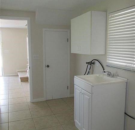 Laundry area with utility sink cabinet & upper cabinet for a