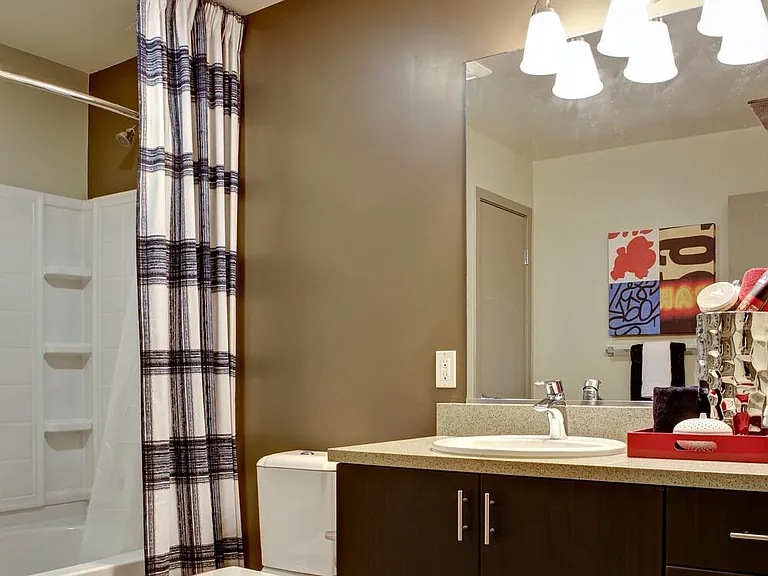 Classic Package I bath with grey speckled granite countertop, espresso cabinetry, and hard surface flooring