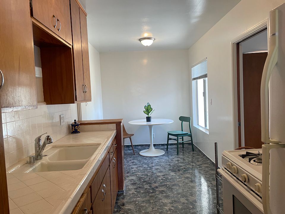 Large kitchen with long countertop and cabinets galore. Open floorpan to Bright dining or workspace area