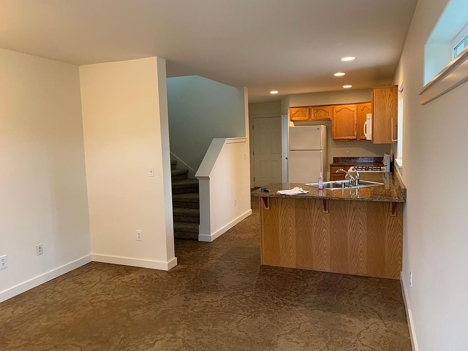 Downstairs common area/entry opens into kitchen w bar to accommodate stools. Can be used as a small living room or dining area.