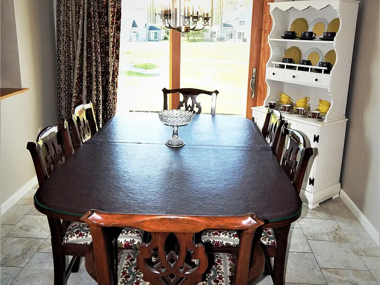 Formal dining room with view of 2 fairways beyond private patio accessed by sliding glass door
