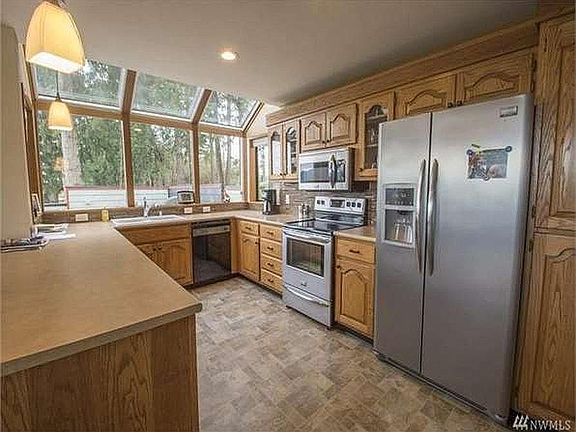 Large kitchen with electric stove.