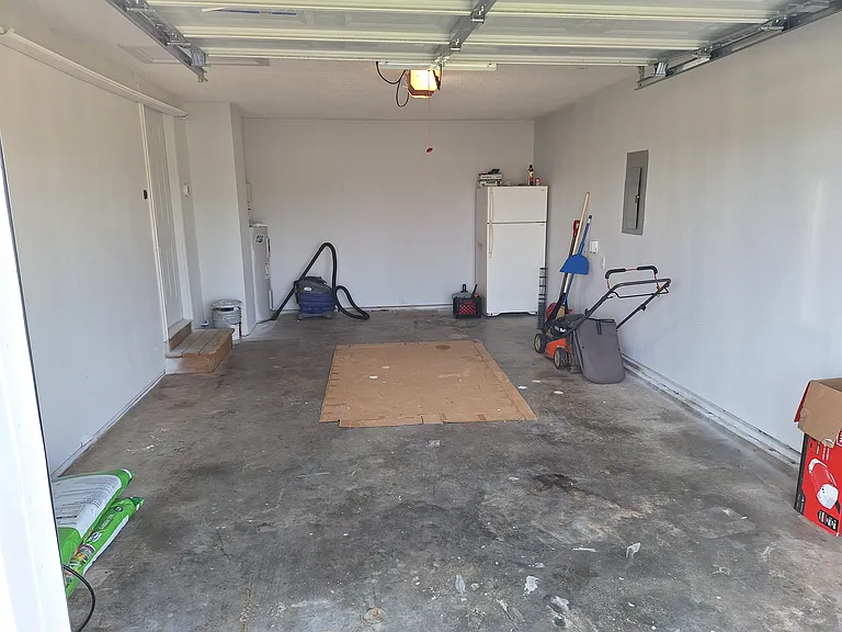 Garage with new electric garage door opener to easily protect your vehicle from the elements, plus added storage space!