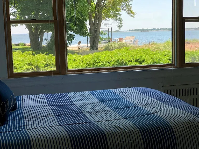 Master bedroom with a spectacular water view, queen sized bed and en-suite bathroom