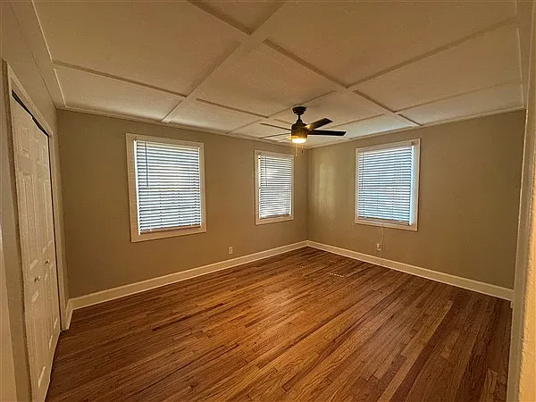 Bedroom 1 is super sunny with a large closet. New wood blinds for privacy and comfort.