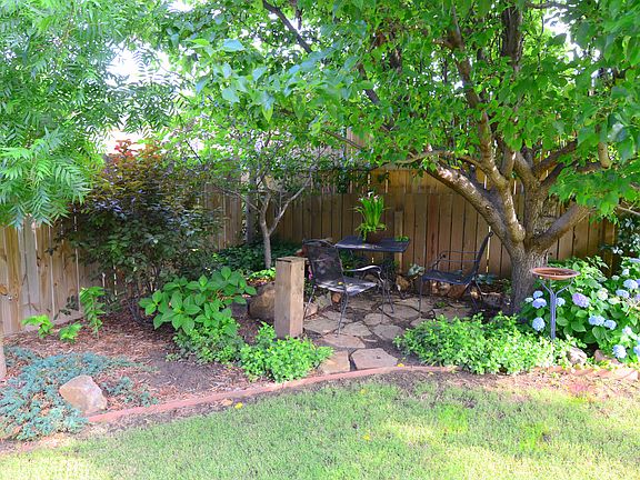 Shady outdoor dining area in the back yard.