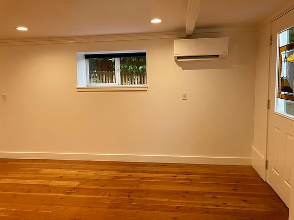 West wall of living room - new mini-split heater/cooler and front side window and door.