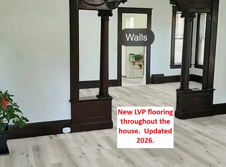 Standing in the foyer looking through the front room to the dining room and the kitchen is beyond