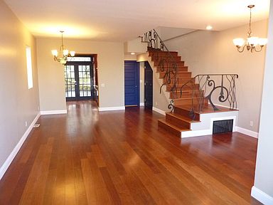 Stunning indonesian plank flooring throughout home. Custom wrought iron bannister on stairs.