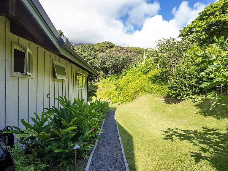 well lit, manicured pathway to downstairs unit